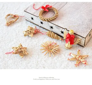 Collection of handmade straw Christmas tree ornaments with festive red ribbons