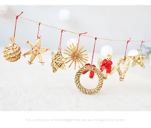 Detailed view of handmade straw Christmas ornaments hanging on a red string