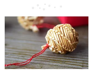 Close-up detail of handcrafted woven straw ball ornament for Christmas tree decoration