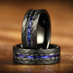 Close-up of black faceted stainless steel ring with vibrant blue galaxy inlay