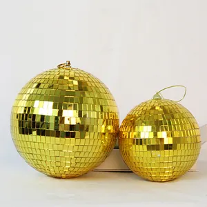 Detailed view of two different sized golden disco mirror balls for festive party decoration