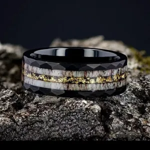 Detailed macro view of a faceted black stainless steel ring with gold foil and bone inlay