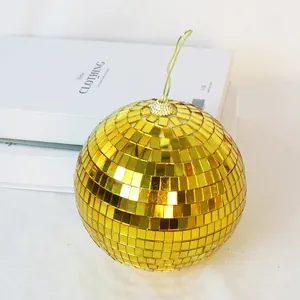 Close-up macro view of a reflective gold mirror disco ball for party decorations