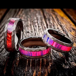 Detailed view of hammered stainless steel rings featuring vibrant purple and red inlays