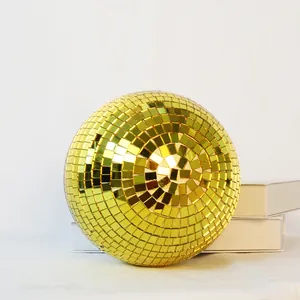 Detailed view of a reflective golden glass mirror disco ball for festive party decor