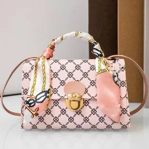 Elegant pink patterned mini crossbody bag featuring a decorative scarf wrapped handle