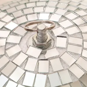 Macro detail view of the metal hanging ring and screw on top of a disco mirror ball
