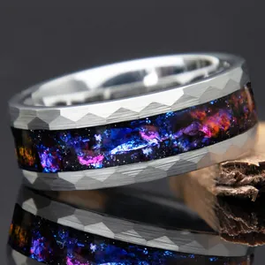 Detailed macro view of hammered stainless steel ring with colorful galaxy inlay details