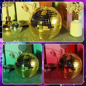 Gold disco mirror ball showing reflective effects in various colored lighting conditions