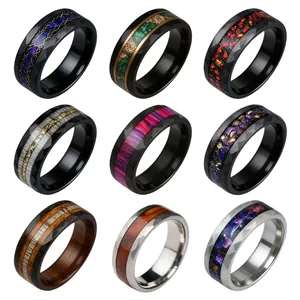 Grid display of nine stainless steel rings with unique colorful inlays and faceted edges