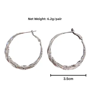 Detailed view of large silver-colored twisted hoop earrings with a 3.5cm diameter measurement