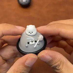 Hand-painted gray seal squishy toy with white bear and lollipop for stress relief.