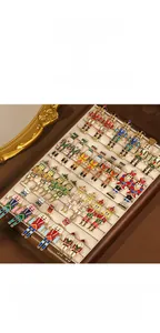 Close-up view showing various styles of pearl and rhinestone nutcracker drop earrings