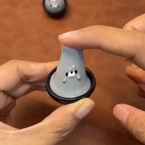 Close-up of a cute gray seal squishy toy being squeezed for stress relief and fun