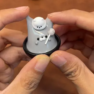 Close-up showing the flexible texture of a seal squishy toy with lollipop accessory.