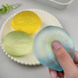 Close-up view of squeezing a translucent lemon-shaped squishy stress relief toy
