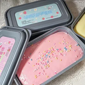 Gros plan d'un jouet gâteau squishy rose avec des vermicelles colorés dans sa boîte grise