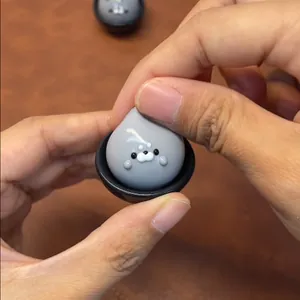 Close-up of a small grey seal squishy toy being squeezed for daily stress relief