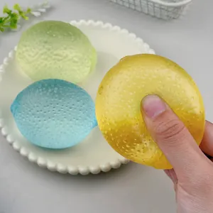 Close-up view of squeezing a yellow lemon stress toy showing soft maltose texture