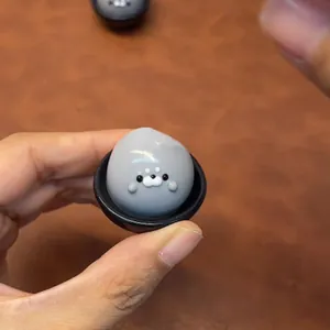 Close-up view of a cute gray seal squishy toy held in hand for stress relief and fun.