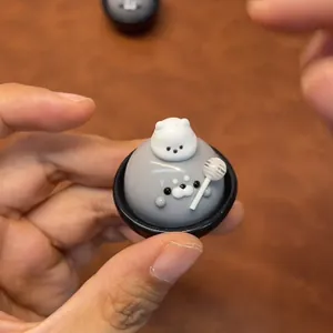 Cute handmade seal squishy toy featuring a lollipop and bear character for stress relief
