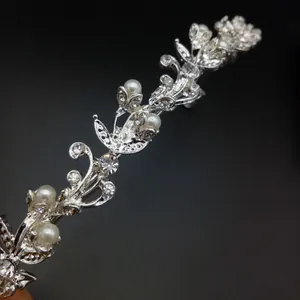 Close-up detail of elegant silver bridal tiara with sparkling crystals and white pearls