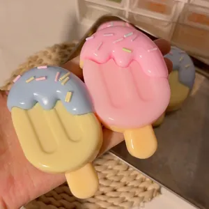 Realistic popsicle squishy toy for stress relief in pastel pink and blue colors.