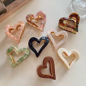 Vintage heart-shaped acetate hair claw clips set in various marbled patterns and colors