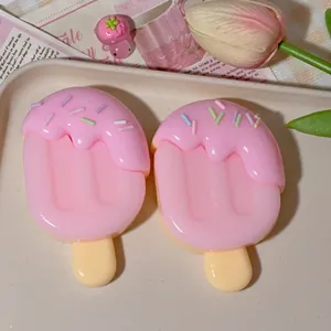 Two cute pink popsicle squishy stress relief toys on a decorative tray