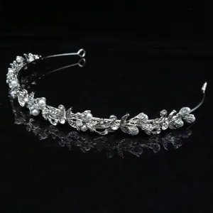 Elegant silver bridal tiara with pearls and rhinestones for weddings or parties.