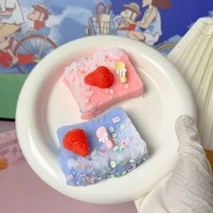 Detailweergave van simulatie aardbeientoast squishy speelgoed met schattige bedeltjes.