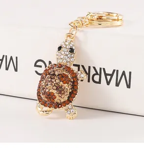 Detailed macro view of a sparkling turtle keychain featuring brown and white rhinestones