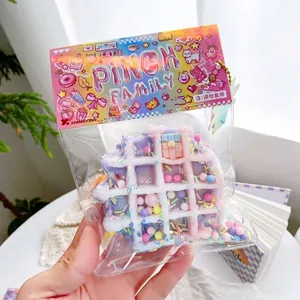 Colorful waffle shaped squishy toy for stress relief in retail packaging