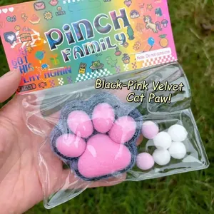 Handheld black and pink flocked cat paw squishy toy for stress relief and decompression