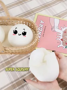 Close-up of slow-rebound bun-shaped squishy toy being squeezed to show soft texture