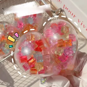 Close-up of heart-shaped stress relief toy filled with colorful miniature ice cubes.