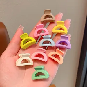 Detailaufnahme von bunten Mini-Haarklammern für Mädchen in einer offenen Handfläche