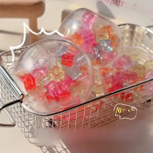 Detailed view of colorful ice cube DIY squeeze balls placed in a minimalist wire basket