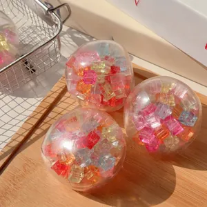 Close-up of vibrant colorful translucent cubes inside a clear stress relief squishy ball