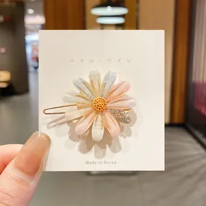 Vue détaillée d'une pince à cheveux fleurie avec des accents de strass brillants