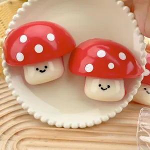 Cute red mushroom squishy toy on a white plate for stress relief and home decoration