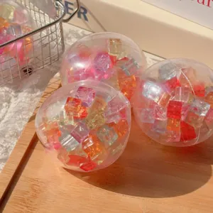 Close-up of colorful ice cube filled transparent squishy toy ball for stress relief