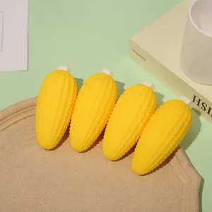 Set of four realistic yellow corn-shaped stress relief squeeze toys displayed on a tray