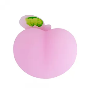 Cute pink peach squishy toy for stress relief with leaf detail on white backdrop