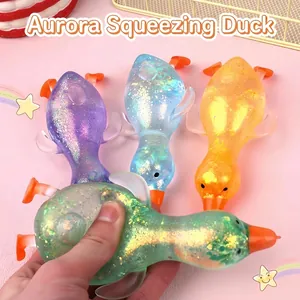 Close-up detail of a colorful glitter maltose duck squeeze toy being compressed by hand