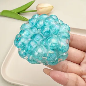 Macro detail of blue pearlescent squishy stress ball toy held in hand for relief
