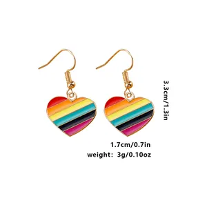 Detail view of rainbow enamel heart drop earrings with dimensions and weight