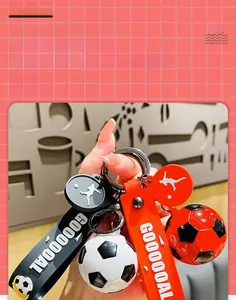 Detailed view of simulation soccer keychains with GOOOOOAL straps in black and red