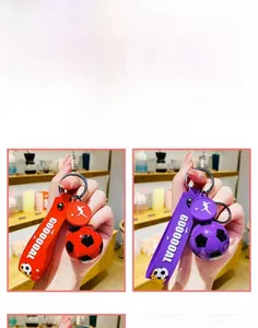 Simulation soccer keychain with GOOOOOAL strap in red and purple variants, detail view