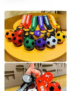 Detailed view of colorful soccer ball keychains featuring GOOOOAL rubber straps for bags.